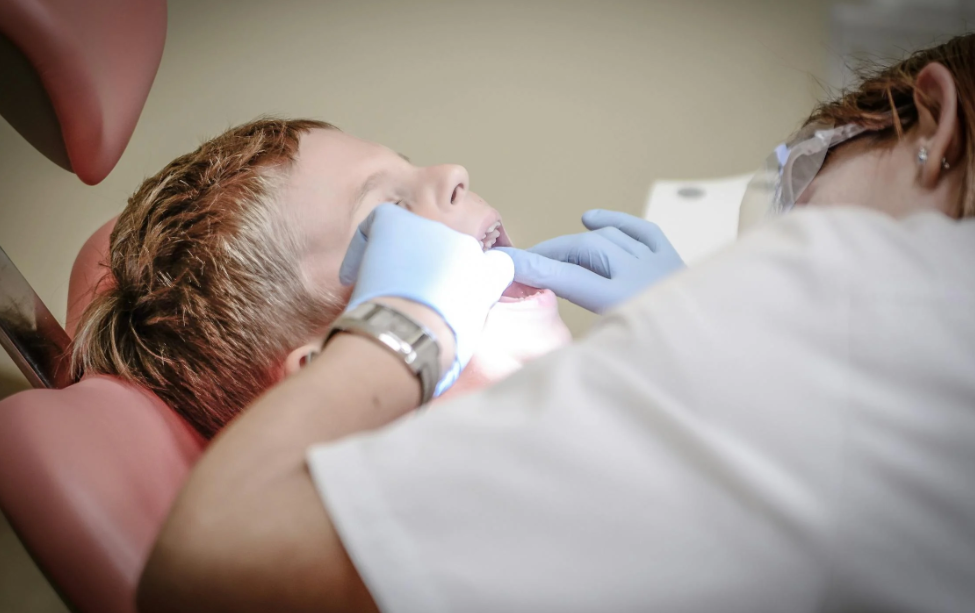 Dentist performing dental surgery